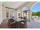 Covered patio features an outdoor dining area with brick pavers and architectural arches at 1211 Aquila Loop, Kissimmee, FL 34747