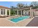 Beautiful backyard pool with a pergola and lots of patio space for lounging in the sun at 1211 Aquila Loop, Kissimmee, FL 34747