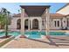 Beautiful pool with brick patio and a pergola with columns, creating a luxurious outdoor living space at 1211 Aquila Loop, Kissimmee, FL 34747