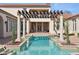 Beautiful pool with a pergola, columns, and access to the main house at 1211 Aquila Loop, Kissimmee, FL 34747