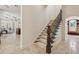 Elegant staircase with decorative wrought iron railings at 1211 Aquila Loop, Kissimmee, FL 34747