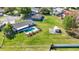 Aerial view of a backyard featuring a pool, shed, and a vast expanse of well-kept green lawn at 1240 Beth Ln, St Cloud, FL 34772