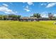 Large, grassy backyard with secure black fencing and mature trees at 1240 Beth Ln, St Cloud, FL 34772