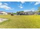 Expansive backyard featuring lush green grass and black fencing at 1240 Beth Ln, St Cloud, FL 34772