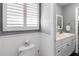 Cozy bathroom featuring a toilet, window and double vanity through doorway at 1240 Beth Ln, St Cloud, FL 34772