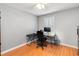 Bright bedroom featuring hardwood floors, a modern desk setup, and a ceiling fan at 1240 Beth Ln, St Cloud, FL 34772