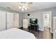 Serene bedroom featuring dark wood floors, a TV, and access to a private bathroom at 1240 Beth Ln, St Cloud, FL 34772