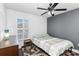 Comfortable bedroom with wood floors, a neutral color palette, and a ceiling fan at 1240 Beth Ln, St Cloud, FL 34772