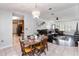 Dining room and living room with a gorgeous chandelier and an open floor plan at 1240 Beth Ln, St Cloud, FL 34772