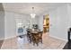 Cozy dining room with a stylish light fixture, table setting and view to the kitchen at 1240 Beth Ln, St Cloud, FL 34772