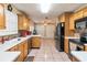 Kitchen with light wood cabinets, stainless steel appliances, and tile backsplash at 1240 Beth Ln, St Cloud, FL 34772