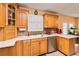 Bright kitchen with wooden cabinets, a white countertop, and stainless steel appliances at 1240 Beth Ln, St Cloud, FL 34772