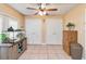 A room with neutral colors and a ceiling fan provides extra room for storage and activities at 1240 Beth Ln, St Cloud, FL 34772