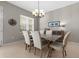 Dining room with modern chandelier and neutral-toned furniture set at 1343 Flagstone Ave, Celebration, FL 34747