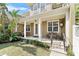 Inviting front porch with seating area, decorative clock, and well-manicured landscaping at 1343 Flagstone Ave, Celebration, FL 34747