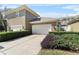 Two-car garage with manicured landscaping; showcasing curb appeal and practicality at 1343 Flagstone Ave, Celebration, FL 34747