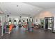 Well-lit gym with modern exercise equipment, including treadmills and weight machines, set against large windows at 1343 Flagstone Ave, Celebration, FL 34747