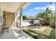 Private outdoor patio with tropical plants and a shaded seating area for relaxation and entertaining at 1343 Flagstone Ave, Celebration, FL 34747