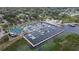 High aerial view of a marina, docks, and a boat house surrounded by water and lush shoreline vegetation at 1422 Indiana Ave, St Cloud, FL 34769