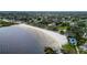 Aerial view of a sandy beach and lake, illustrating the property's access to waterfront recreation at 1422 Indiana Ave, St Cloud, FL 34769