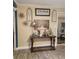 A decorated entryway featuring a wooden console table with flowers and decorative objects at 1422 Indiana Ave, St Cloud, FL 34769