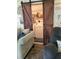 View of a laundry room, behind barn doors, with washer, dryer, shelving, and decor at 1422 Indiana Ave, St Cloud, FL 34769