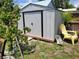 Backyard shed with ample storage space and a yellow chair at 1422 Indiana Ave, St Cloud, FL 34769