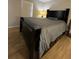 Comfortable main bedroom with a large bed, wood floors, and soft lighting at 1649 W Oak Ridge Rd # 1649C, Orlando, FL 32809