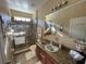 Bathroom featuring walk-in shower, granite vanity, decorative mirror and vanity lighting at 1820 Trophy Bass Way, Kissimmee, FL 34746