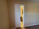 Ensuite bathroom featuring tan walls and granite counters visible from Primary bedroom at 1820 Trophy Bass Way, Kissimmee, FL 34746