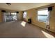 Spacious bedroom featuring neutral carpet, beige walls, and sliding glass doors to the outside deck at 1820 Trophy Bass Way, Kissimmee, FL 34746