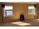 Bedroom featuring neutral carpet, beige walls, two windows, and a dark wood cabinet at 1820 Trophy Bass Way, Kissimmee, FL 34746