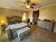 Spacious main bedroom with tile floors, ceiling fan, and furniture at 1820 Trophy Bass Way, Kissimmee, FL 34746