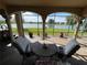 Charming patio setup with seating area overlooking the lake and well manicured lawn at 1820 Trophy Bass Way, Kissimmee, FL 34746