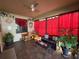 Enclosed sunroom with tile floors and red curtains at 1820 Trophy Bass Way, Kissimmee, FL 34746