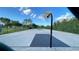 Outdoor basketball court with multiple hoops and green perimeter fencing at 1966 Derby Glen Dr, Orlando, FL 32837