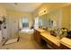 Bright bathroom features a soaking tub, glass shower, and vanity area with tile flooring and a large mirror at 1966 Derby Glen Dr, Orlando, FL 32837
