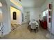 Dining area with a long table, seating for eight, tile flooring, red accent decor, and decorative lighting at 1966 Derby Glen Dr, Orlando, FL 32837
