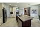 Open kitchen with a center island, stainless steel appliances, and custom cabinetry for ample storage at 1966 Derby Glen Dr, Orlando, FL 32837
