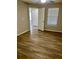 Spacious bedroom featuring wood-look floors, ceiling fan, and neutral colors at 2212 Grand Cayman Ct # 1616, Kissimmee, FL 34741