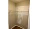 Walk-in closet with a single shelf and wood-look flooring at 2212 Grand Cayman Ct # 1616, Kissimmee, FL 34741