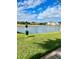 Scenic community view with pet waste station next to the pond and apartment buildings in the background at 2212 Grand Cayman Ct # 1616, Kissimmee, FL 34741