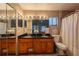 Bathroom with a double sink vanity, neutral tiling, and a large mirror at 233 River Chase Dr, Orlando, FL 32807