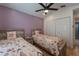 Bright bedroom featuring two twin beds with wooden headboards and a ceiling fan at 233 River Chase Dr, Orlando, FL 32807