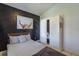 Stylish bedroom featuring a modern accent wall, closet space, and cozy bed at 233 River Chase Dr, Orlando, FL 32807