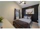 Cozy bedroom with modern black accent wall, stylish decor, and window view at 233 River Chase Dr, Orlando, FL 32807