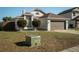 A well-kept home featuring a neat lawn and a convenient two-car garage at 233 River Chase Dr, Orlando, FL 32807