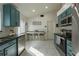 Well-lit kitchen featuring blue cabinetry, stainless steel appliances, and bright interiors at 233 River Chase Dr, Orlando, FL 32807