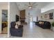 Bright living room with a vaulted ceiling, brick fireplace, and tile floors at 233 River Chase Dr, Orlando, FL 32807