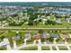 Aerial view of homes in a community with mature trees, pools and well-maintained yards at 2408 Sweetwater Blvd, St Cloud, FL 34772